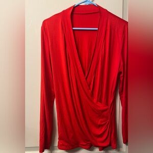 Women’s red plunging v-neck top. Size L